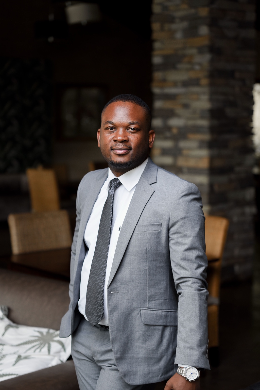 Brian Munyawarara in a grey suit